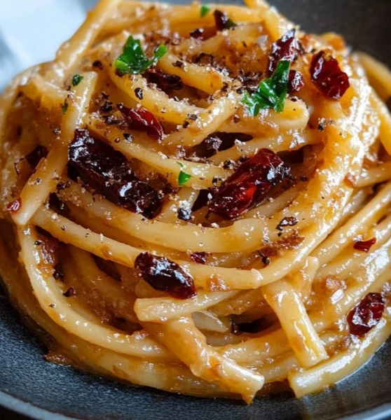 Spaghetti with caramelized onions and chili flakes served as a simple dinner idea