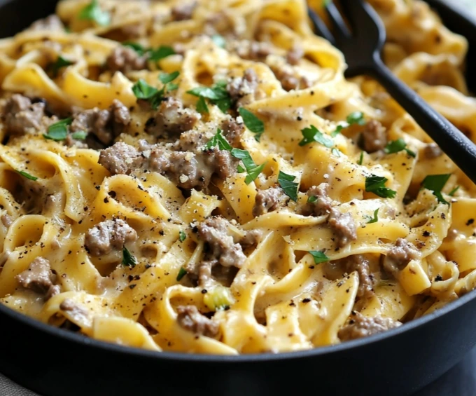 One-Pot Creamy Beef and Garlic Butter Pasta served hot in a skillet with fresh herbs