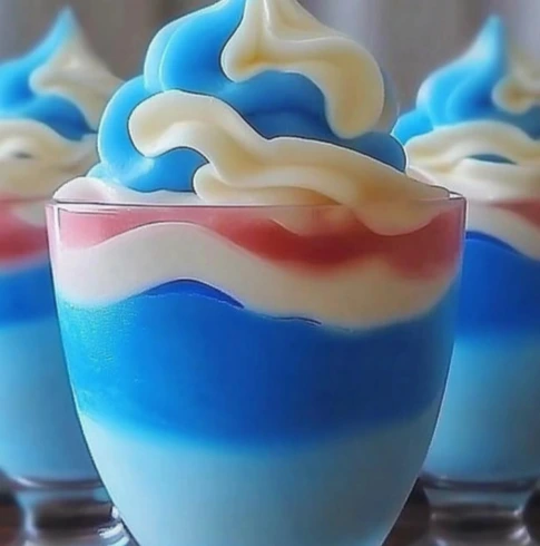red-white-blue-layered-parfait.jpg" alt="Red, White & Blue Layered Parfait in glass jars - festive Fourth of July dessert