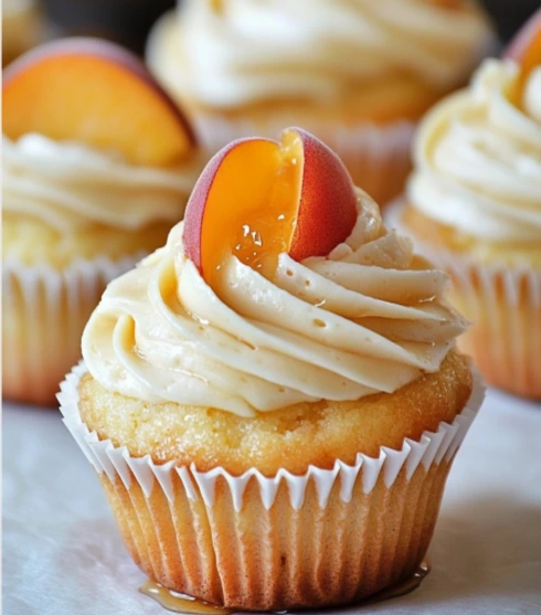Peach Honey Cheesecake Cupcakes topped with fresh peaches and honey drizzle